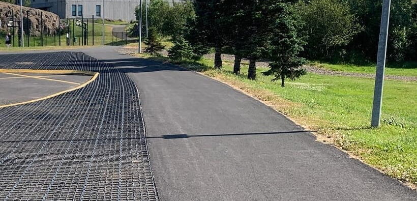 Ecoraster permeable pavers installed next to a asphalt driveway