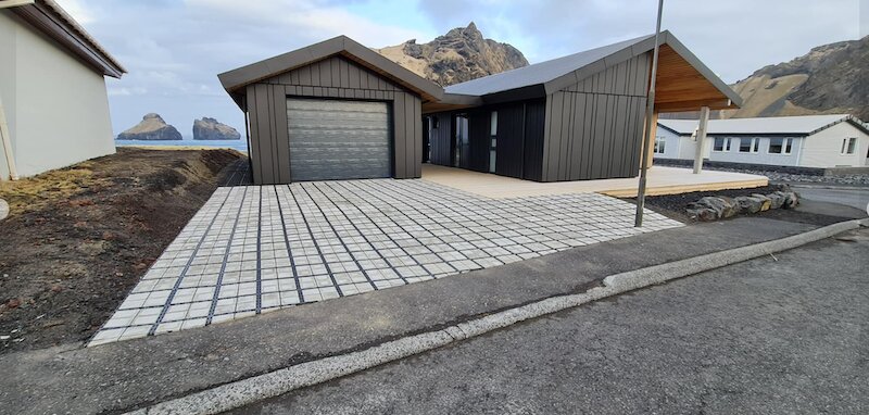 Modern home near the water with an eco-friendly Ecoraster permeable driveway.
